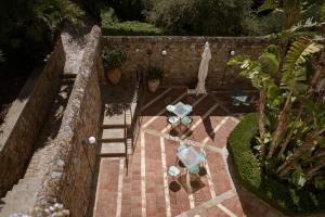 an overhead view of a patio with tables and a umbrella at Villa Dei Melograni Boutique Hotel in Cefalù