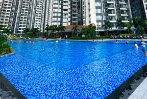 a large blue swimming pool with people in it at R&F Princess Cove Swimming View By TGW STUDIO in Johor Bahru