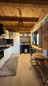 a kitchen with a table and a dining room at Vila Tea Durmitor in Žabljak