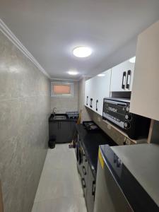 a small kitchen with a stove and a sink at PORTO MATRUH-modern home in Marsa Matruh