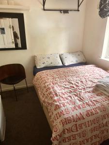 a bedroom with a bed and a chair at Covenant property limited in London