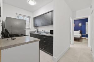 a kitchen with a sink and a stove top oven at Harding Apartments by Andes STR in Miami Beach +174 photos