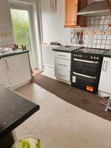 a kitchen with a black stove top oven at Covenant property limited in London