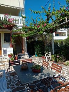 a table and chairs with flowers on a patio at Villa Joanna-1 in Batsi