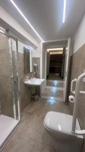 a bathroom with a toilet and a sink and a shower at Caputaquis in Capaccio-Paestum