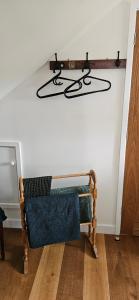 a room with a bench and a shelf on the wall at White Cottage Loft in Newtown Limford