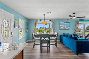 a living room with a blue couch and a table at Happy Mermaid Retreat in Hernando Beach