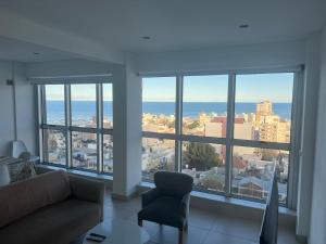 a living room with a view of the ocean at Espacio Chacabuco in Comodoro Rivadavia