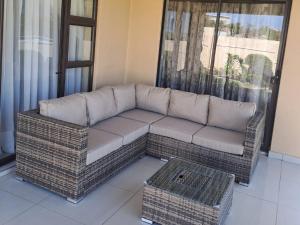 a couch in a living room with a window at River Valley Guest House in Butterworth