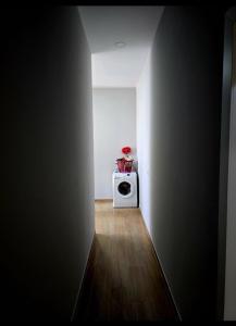 a hallway with a white microwave in a room at Fabio's house in Pogradec