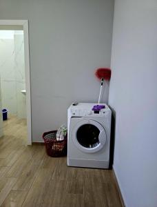 a washing machine in the corner of a room at Fabio's house in Pogradec