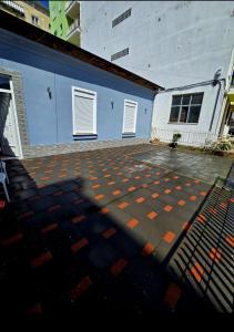 an empty parking lot in front of a blue building at Fabio's house in Pogradec +2 photos