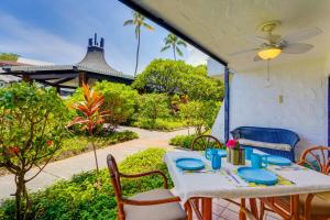 a table and chairs on a patio at 50 Feet to Ocean Kona Deluxe Ground-Floor Unit! in Kailua-Kona