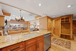 a kitchen with a sink and a living room at Lodge Tower 694 Two Bedroom Residence in Vail