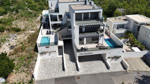an aerial view of a white house with a swimming pool at Luxurious Sea-view 3BR Apartment with Private Pool-Villa Quadris-Crikvenica in Crikvenica