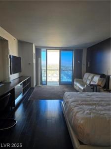 a large hotel room with a bed and a couch at Palms Place Hotel Mountain View with Open Balcony in Las Vegas