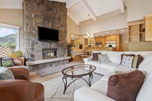 a living room with a couch and a fireplace at Lodge Tower 778 Two Bedroom Residence in Vail