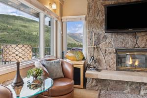 a living room with a fireplace and a television at Lodge Tower 778 Two Bedroom Residence in Vail