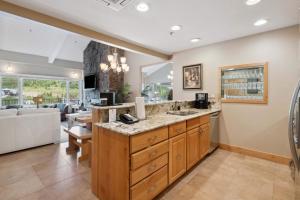 a kitchen with a sink and a living room at Lodge Tower 778 Two Bedroom Residence in Vail