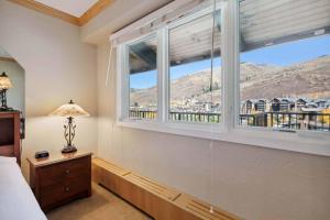 a bedroom with a window with a view of a city at Lodge Tower 782 in Vail