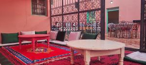 a room with a table and a table and chairs at Chambre partagée Hostel DAIFLAH in Oulad Rguia +16 photos