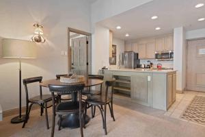 a kitchen with a table and chairs and a counter at Lodge Tower 786 Two Bedroom Residence in Vail