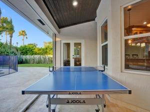 a ping pong table in the middle of a house at Casa Fina Miami Near Beaches 