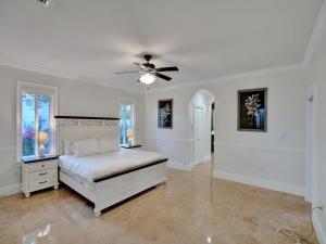 a white bedroom with a bed and a ceiling fan at Casa Fina Miami Near Beaches  +70 photos