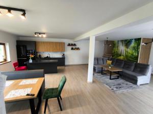 a living room with a couch and a table at domek u fiedora in Pieniążkowice