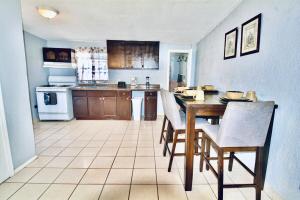 a kitchen with a table and chairs and a kitchen with at Entire Home Near Yarbrough I 10 in El Paso +18 photos