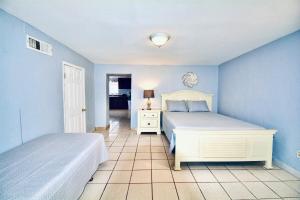 a bedroom with two beds and a blue wall at Entire Home Near Yarbrough I 10 in El Paso