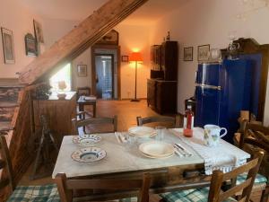 a dining room with a table with plates on it at Casa Gagliano Aterno in Gagliano Aterno
