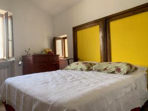 a bedroom with a bed with a white comforter at Casa Gagliano Aterno in Gagliano Aterno