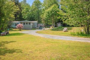 a gravel road leading to a caravan in a yard at 13 Mi to Acadia Artistic Retreat in Nature in Trenton