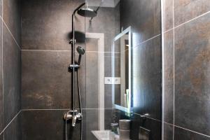 a shower with a glass door in a bathroom at Six Lamps on Masarykova in Zagreb +14 photos