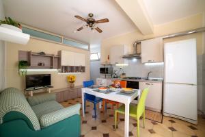 a kitchen with a table and chairs in a room at Casa fronte mare a San Saba in Messina