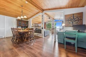 a kitchen and dining room with a table and chairs at Bay & Birch Getaway - Lakefront Living in Wiarton +32 photos