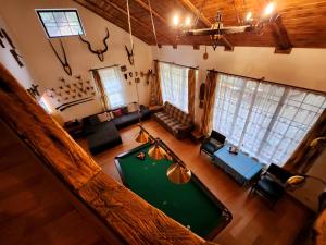 an overhead view of a living room with a pool table at Cabana Oops Foisorul ascuns in Vama