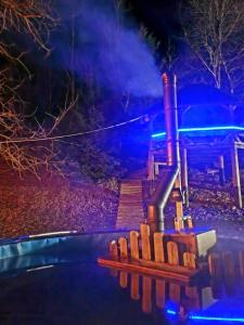 a playground at night with blue lights at Cabana Oops Foisorul ascuns in Vama