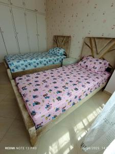 a bedroom with a bed with a comforter on it at Appartement familial au centre de Nador Ville in Nador