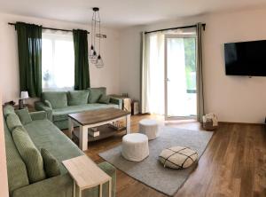 a living room with a couch and a table at Prázdninový dům Dírná in Dírná