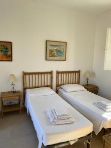 two beds sitting next to each other in a room at Casale Vignazze in Punta Secca +27 photos