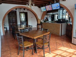 a dining room with a wooden table and chairs at Hotel El Descanso Cultural in Antigua Guatemala