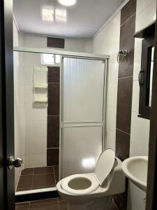 a small bathroom with a toilet and a shower at Brisas Centro Historico in Santa Marta +29 photos