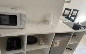 a white counter top with a microwave on it at Eco Dpto Estudio El golf 9 in Santiago