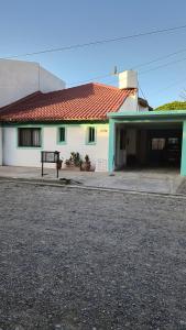 a white house with a bench in front of it at Casa 4 VLG in Las Grutas