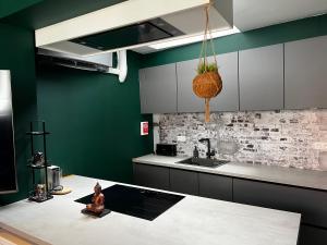 a woman sitting on a table in a kitchen at Cosy Boutique hotel leuven - self check in with airco !!! in Leuven