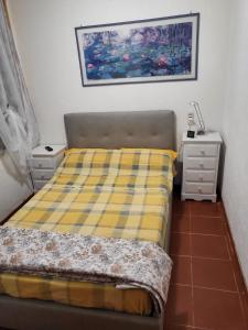 a bedroom with a bed and two night stands at Residenza Verde Mare Cugnana village in Cugnana Verde