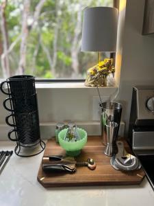 a cutting board with a lamp and a bowl on a counter at Sea garden in Old Bight