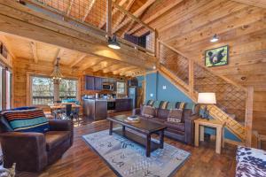 a living room with a staircase in a log cabin at Honey Bear in Rocky Grove